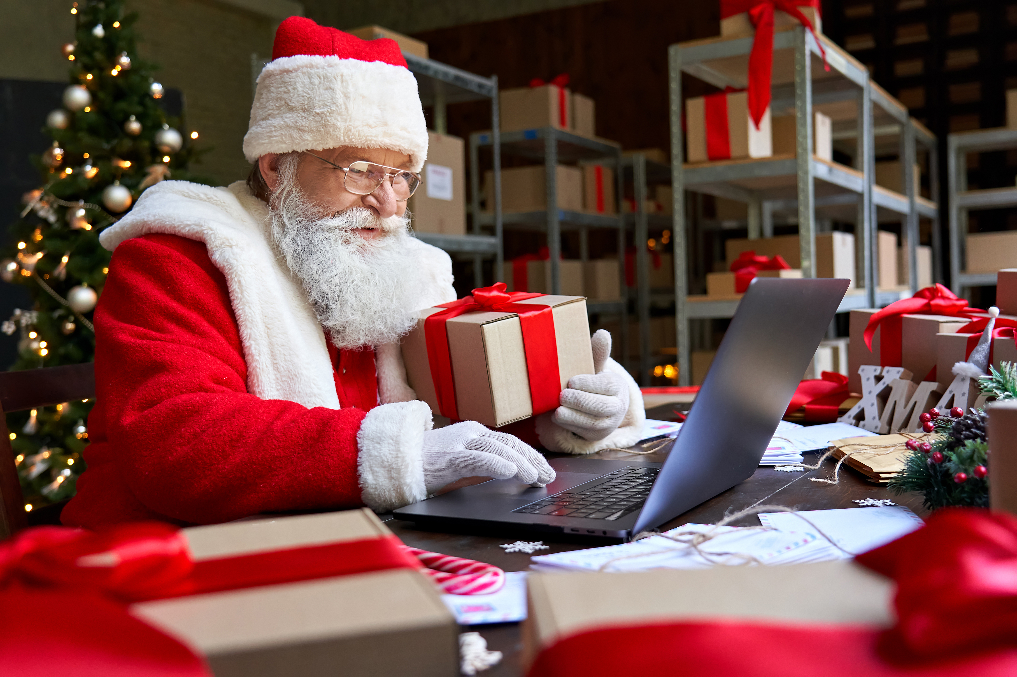 father christmas buying virtual gifts on a laptop
